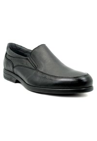 Zapato negro de cuero de tipo slip-on con un acabado suave, puntera redondeada y detalles de costura sutiles. Suela de goma plana para mayor comodidad y estabilidad.