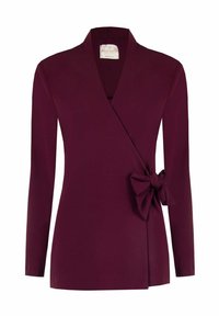 Top avvolgente bordeaux con maniche lunghe, scollo a v e un fiocco decorativo sul lato. Realizzato in tessuto morbido e liscio.