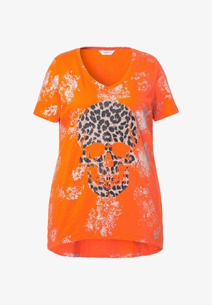 T-shirt arancione a maniche corte con scollatura a V, caratterizzato da una grafica di teschio con stampa leopardata e uno sfondo con pattern testurizzato e spruzzato.