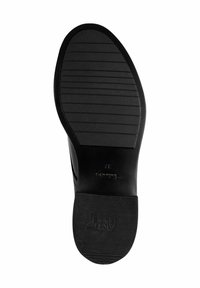 Black shoe sole with a textured, grooved surface. Features a rounded shape and embossed brand logo. Non-slip design for grip and stability.