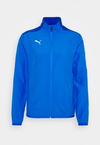 Blue polyester jacket with a high collar, full zipper, long sleeves, and white Puma logo on the left chest and shoulder. Smooth texture.