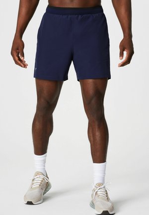 Navy athletic shorts with an elastic waistband, made of lightweight fabric, featuring two side pockets and a minimalist design.