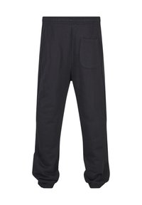 Pantalon décontracté noir avec taille et poignets élastiques, doté d'une seule poche arrière sur le côté droit.