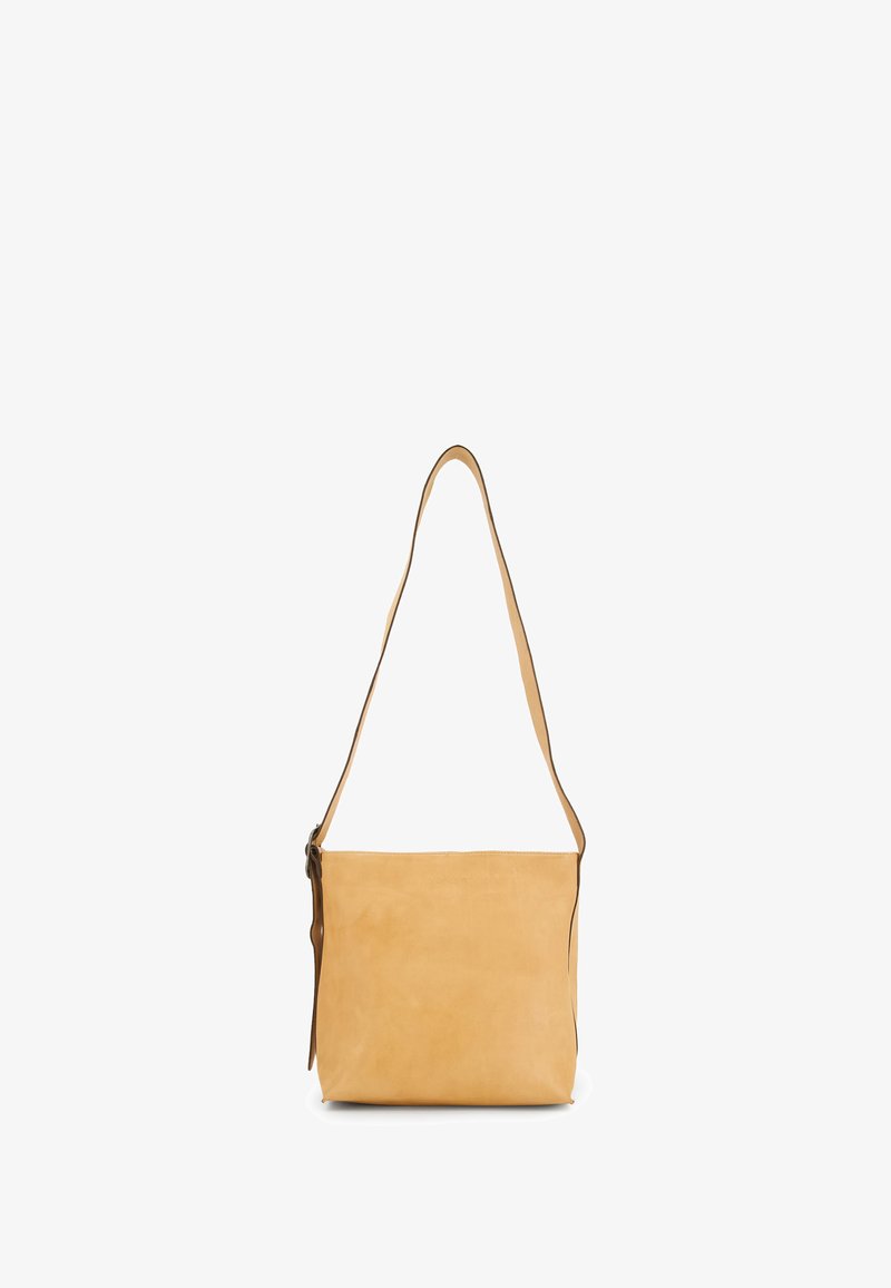 Tan leather shoulder bag with a smooth texture, featuring a long adjustable strap and a zip closure. Minimalist rectangular design.