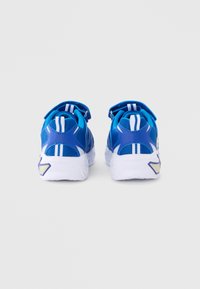 Blue athletic shoes with mesh and synthetic material, uniquely shaped with a white sole, featuring blue and white accents and stripes.