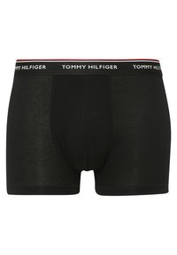 Black cotton boxer briefs featuring a white waistband with "TOMMY HILFIGER" logo and a contrasting red accent stripe. Smooth texture.