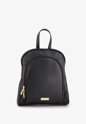 Black leather backpack with a textured finish, curved front pocket, dual zippers, and gold hardware accent featuring brand name plate.