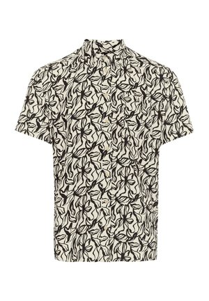 Chemise à manches courtes en crème avec motif floral noir ; elle possède un col et une fermeture à boutons à l'avant. Le tissu a une texture lisse.