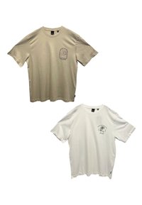 Two short-sleeve t-shirts: one beige with a graphic design on the chest, one white with a green print. Both have a relaxed fit and cotton material.