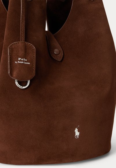 Καφέ τσάντα Polo Ralph Lauren από σουέτ με δερμάτινη ετικέτα και μικρό λευκό λογότυπο παίκτη πόλο κοντά στην κάτω δεξιά γωνία.