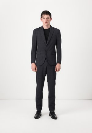 Dark gray suit with a subtle check pattern, featuring a single-breasted jacket and straight-leg trousers, paired with black shoes.