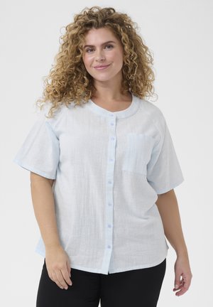 Light blue, short-sleeve button-up shirt made of textured fabric, featuring a chest pocket and a round neckline.