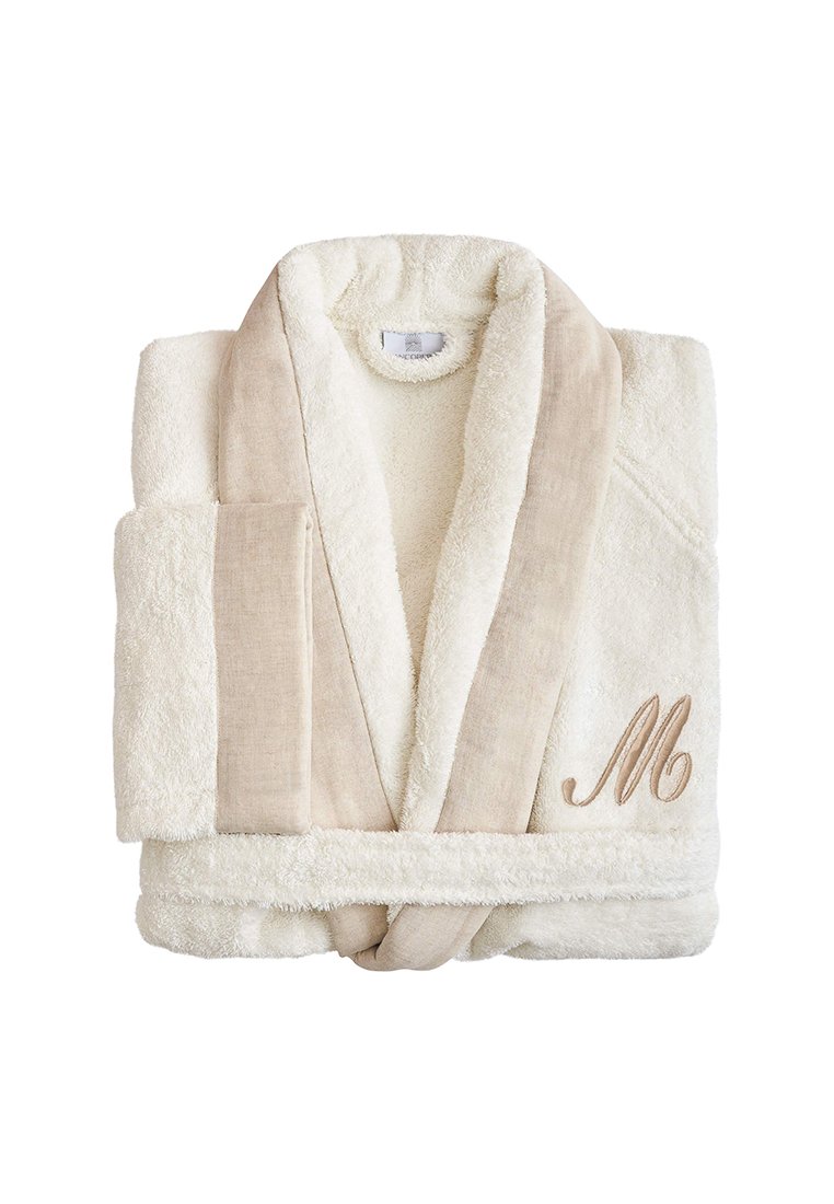 Witte badjas van terrycloth met een tan linnen kraag en riem. Voorzien van een geborduurde initialen "M" aan de linkervoordel. Zachte textuur.