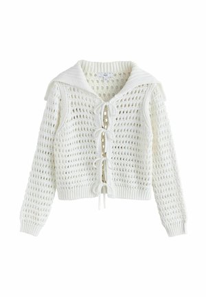 Cardigan bianco lavorato a maglia con motivo a trama aperta, colletto in stile marinaresco e fiocchi legati sul davanti come chiusure.