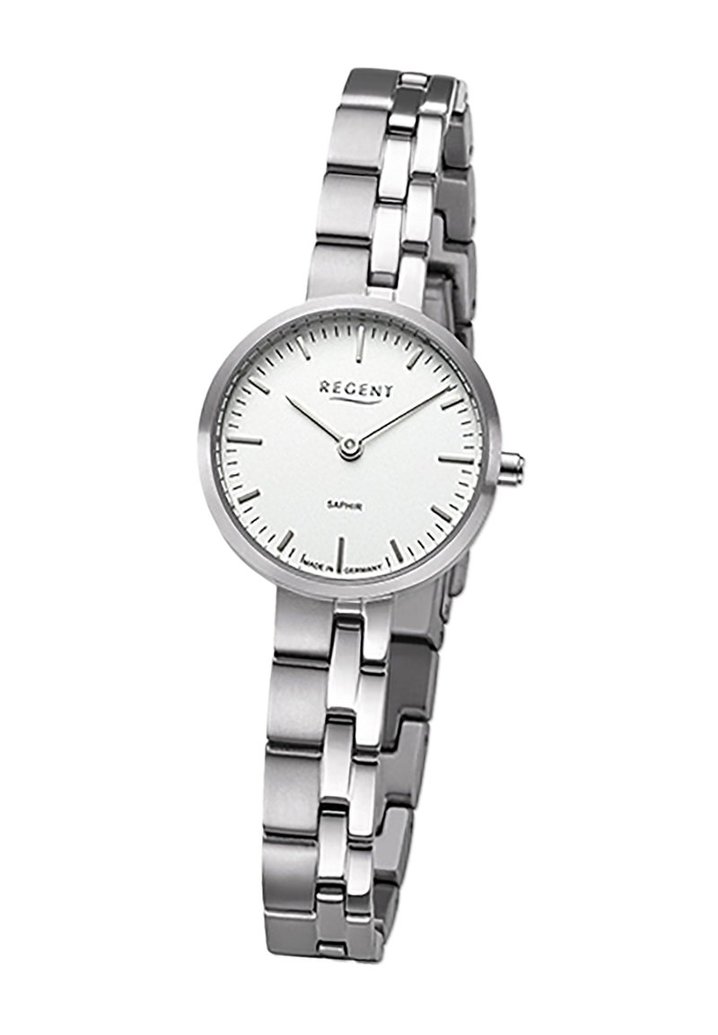 Montre en acier inoxydable argenté avec un cadran blanc rond, marqueurs d'heure argentés minimalistes et un mouvement à quartz. Dotée d'un bracelet à maillons.