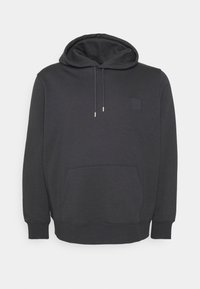 Sweat à capuche gris foncé avec une poche avant, des cordons de serrage et un petit patch carré. Confectionné en tissu doux avec des poignets et un ourlet côtelés.