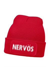 Red knit beanie with a textured surface, featuring a white rectangular patch displaying the word "NERVÖS" in bold, stylized lettering.