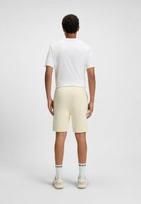 BOSS SEWALK - Pantaloni sportivi - open yellow seventeen
