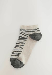 Čarapa do gležnja u svijetloj krem boji s crnim i sivo-zebrastricama, rebrastim rubom, te tamno sivoj peti i prstima.