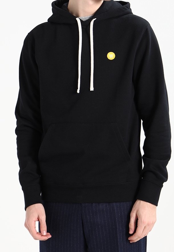 Black hooded sweatshirt with a front pocket, white drawstrings, and a small yellow logo on the chest. Soft fabric and relaxed fit.