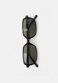 Black plastic sunglasses with rectangular frames, dark lenses, and thin arms. Engraved text visible on the inner frame.
