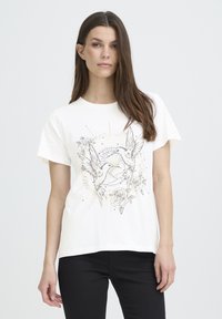 White cotton t-shirt featuring a graphic print of two birds and roses, accented with gold and black lines. Short sleeves, relaxed fit.