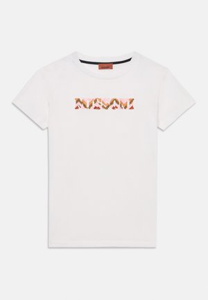 Vit bomullströja med en dekorativ logotyp i rosa, guld och röda paljetter. Rund halsringning och korta ärmar med rak fåll.