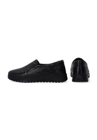 Black slip-on shoes with a textured surface, featuring a thick black sole and subtle stitching details. Minimalist design with no visible hardware.