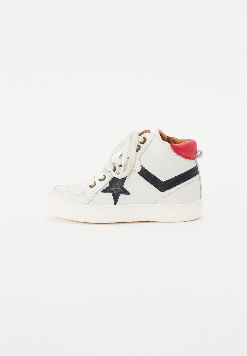 White high-top sneaker made of leather, featuring a navy star and chevron pattern, red heel accent, and beige laces. Textured toe cap.