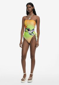 Costum de baie dintr-o singură piesă, fără bretele, cu un gradient de la portocaliu la verde, având un grafic cu colibri și legături pe lateral pentru ajustabilitate.