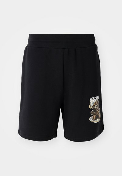 Sorte bomullsshorts med elastisk midje, med en bjørnegrafikk og "Moschino"-tekst på venstre ben. Glatt tekstur, knelengdes design.
