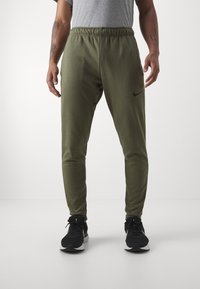 Nike Performance TAPER - Pantalones deportivos - medium olive/black