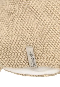 Beige knit fabric with a textured pattern and a soft interior. Features a small tag with the brand "Sternstaler" stitched on the edge.