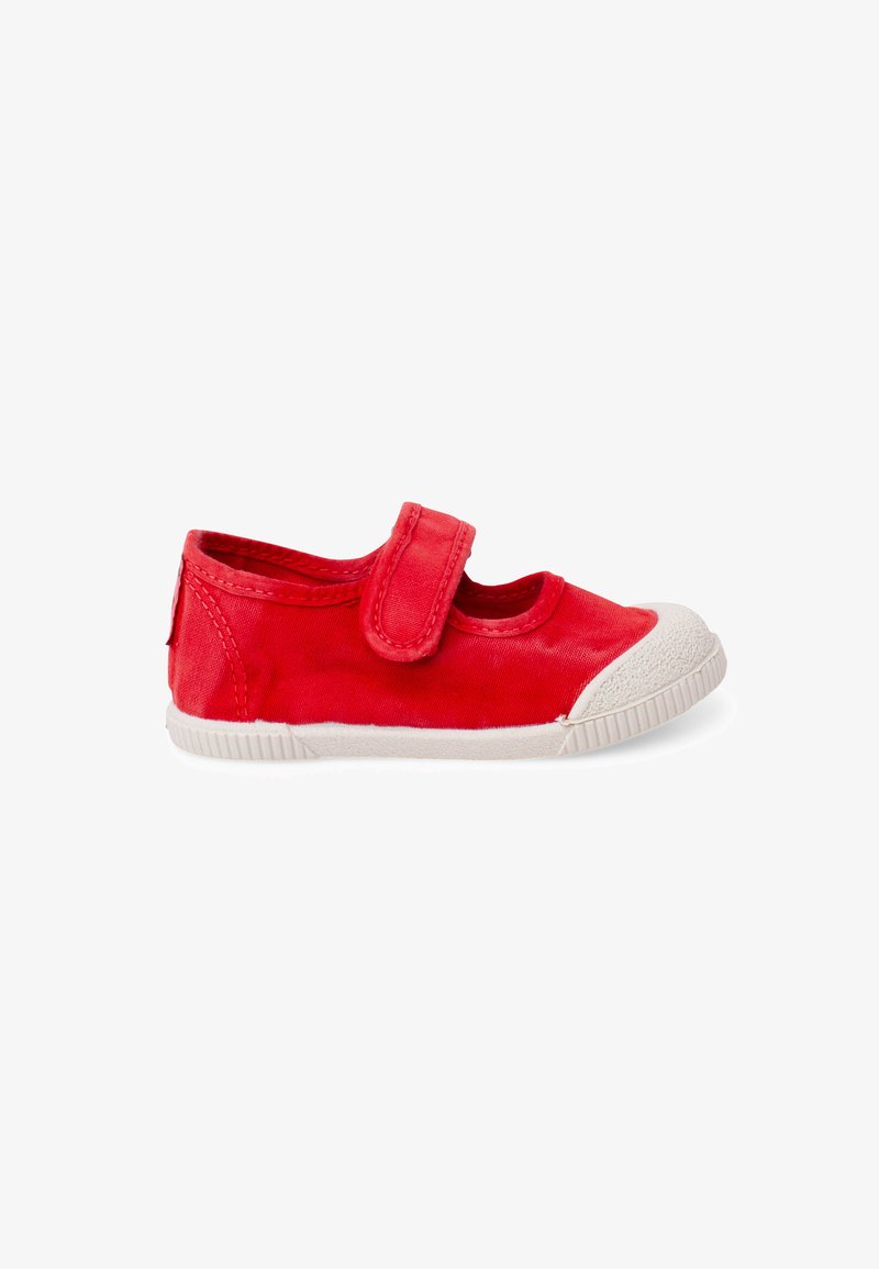 Chaussure en toile rouge pour enfants avec embout et semelle en caoutchouc blanc, avec une seule bride Velcro sur le dessus.