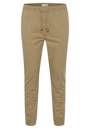 Beige bomulds-casualbukser med elastik i taljen, snørre og elastiske manchetter ved anklerne.