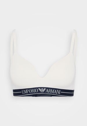 White bra with a V-neck design, soft material, and thin straps; features a navy branded elastic band with "Emporio Armani" text.