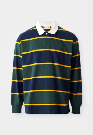 Polo majica z dolgimi rokavi, ki ima zelene, temno modre in rumene črte, z belim ovratnikom in majhnim logotipom na prsih. Pameten material.