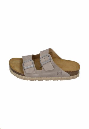 Beige suede slide sandal with two adjustable straps and metal buckles, contoured cork footbed, and beige textured sole.