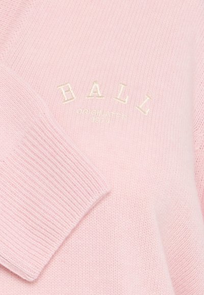 Svijetloružičasti pleteni pulover s rebrastim rukavima i okruglim izrezom, s vezanim natpisima "BALL" i "ORIGINATED 1974" u bijeloj boji.