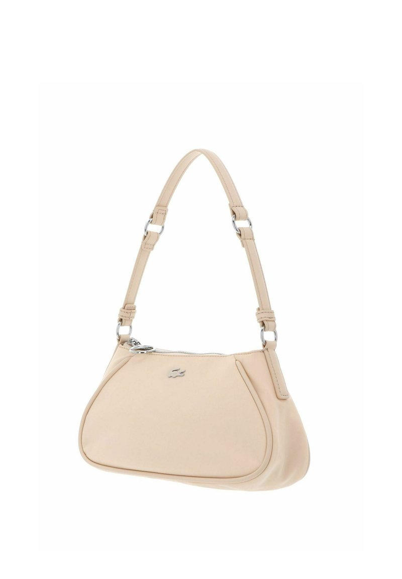 Beige leather shoulder bag with adjustable strap, top zipper, and small silver logo on front.