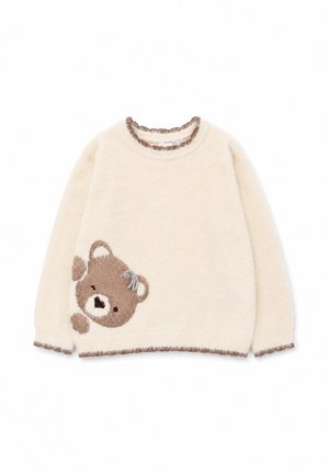 Maglione peloso color crema con bordatura marrone e grande disegno di faccia di orsetto nella parte inferiore sinistra, con un piccolo fiocco sull’orecchio.