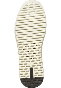White rubber shoe sole with patterned grooves and perforations for ventilation. Features a black section at the heel, labeled "GEOX."
