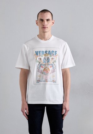 White cotton t-shirt featuring a colorful graphic of seahorses and seashells, with "VERSACE" prominently displayed at the top.