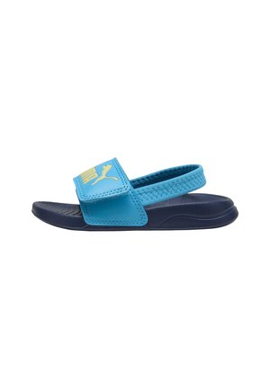 Sandale ouverte, bleue et marine, avec une sangle ajustable et une sangle de talon arrière, arborant un logo Puma sur la sangle avant.