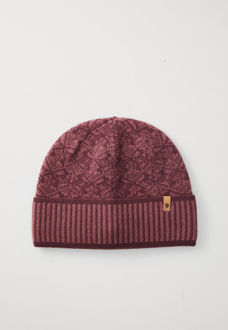 Maroon knitted beanie with a patterned top and ribbed band. Features a small brown label on the side. Soft texture with warm color tones.