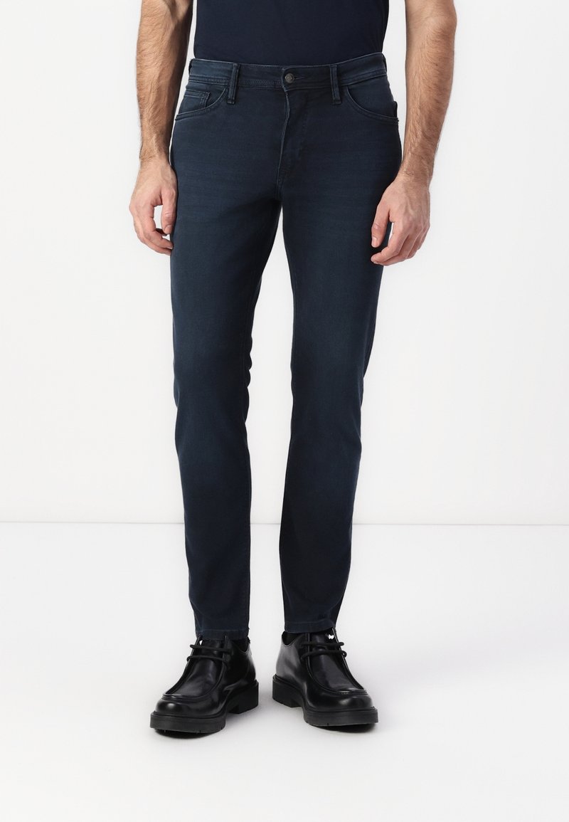 Dark blue slim-fit jeans made of denim, featuring belt loops, front and back pockets, with a smooth texture and minimalistic design.