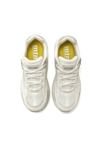 Zapatillas blancas con parte superior de malla y cuero, cordones, cuello acolchado y una plantilla amarilla con la marca "mtn". Punta redondeada y diseño texturizado.