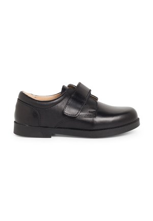 Black leather shoe with a smooth surface, round toe, and a Velcro strap. Low heel and textured rubber sole for stability.