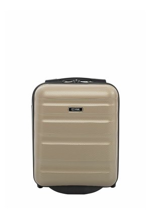 Kompaktowa beżowa walizka z twardą powłoką o fakturowanej powierzchni, czarną rączką i podwójnym zamkiem błyskawicznym, stojąca pionowo na białym tle.