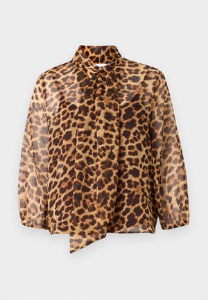 Blouse transparente à manches longues avec un motif léopard et un détail de col noué. Elle présente une coupe ample et un tissu léger et doux dans des tons beige et marron.